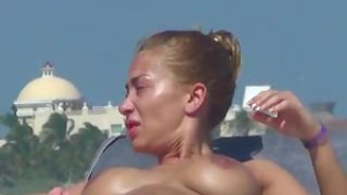 Gorgeous woman topless beach sunbathing