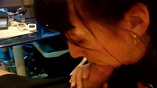 Brunette giving a very passionate POV blowjob to her husband on the couch