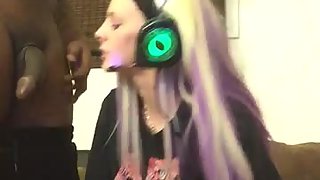 Blonde amateur girl sucks a black cock while playing video games