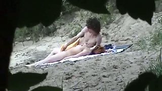 Voyeur camera capturing couple on beach having sex in public