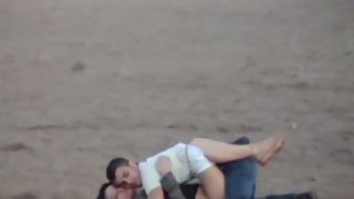 Young lovers making out on the beach voyeur sex tape long lens camera